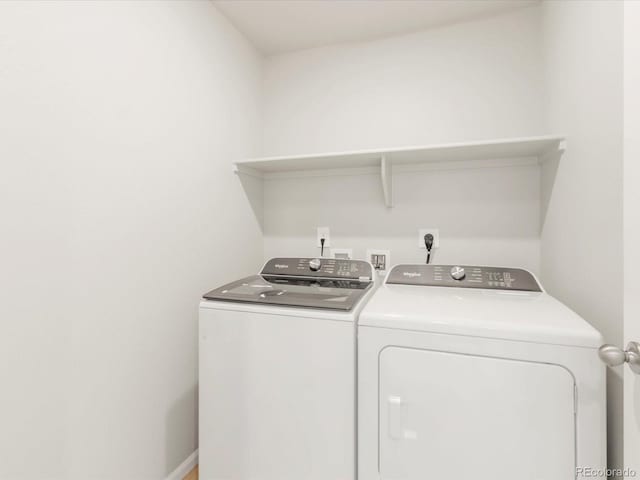 laundry area with laundry area, baseboards, and separate washer and dryer