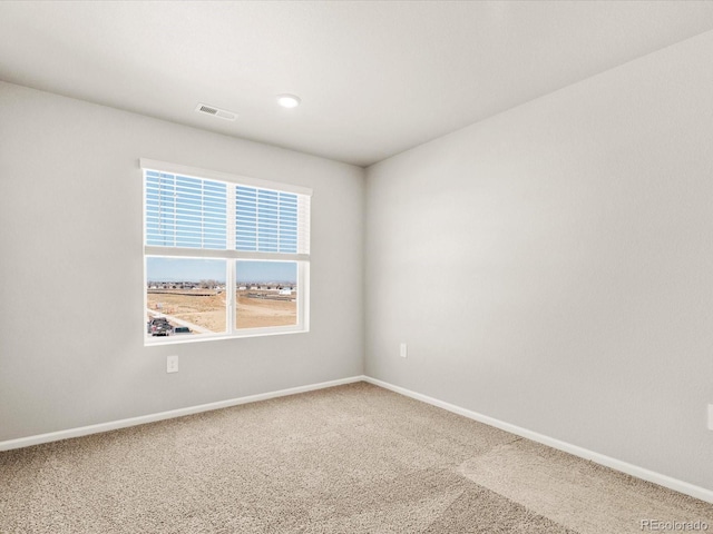 carpeted empty room with baseboards and visible vents