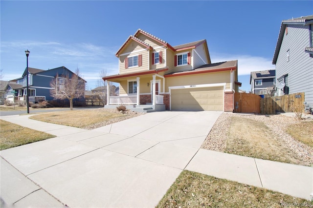 view of front of home featuring brick siding, fence, a porch, driveway, and a gate