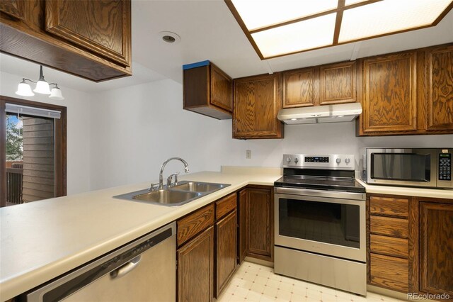 kitchen featuring appliances with stainless steel finishes, light tile patterned floors, and sink