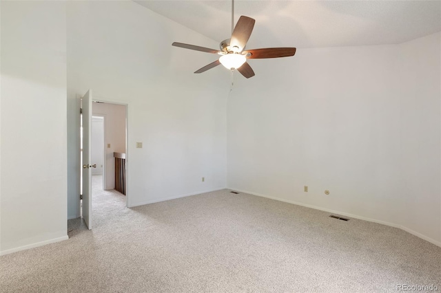 carpeted spare room featuring ceiling fan and high vaulted ceiling