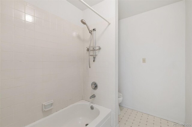 bathroom with toilet, tile patterned floors, and tiled shower / bath combo