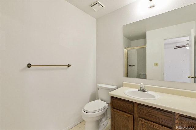 bathroom with toilet, vanity, ceiling fan, and tile patterned flooring