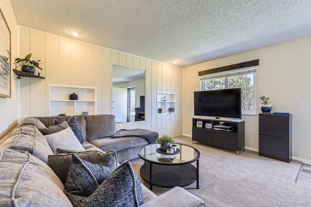 living room featuring a textured ceiling, light carpet, and a wealth of natural light