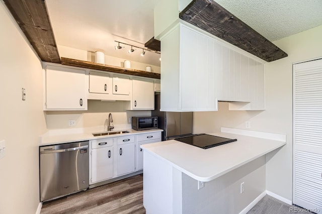 kitchen with white cabinets, a sink, light countertops, a textured ceiling, and stainless steel dishwasher
