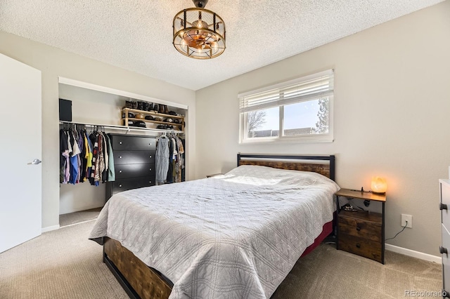 bedroom featuring baseboards, carpet flooring, a closet, and a textured ceiling
