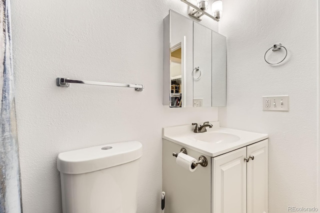 bathroom with toilet and vanity