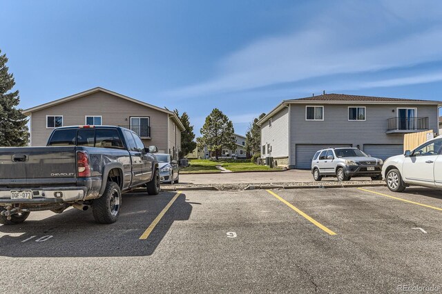 uncovered parking lot featuring a residential view