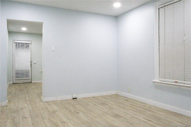 unfurnished room featuring recessed lighting, baseboards, and light wood finished floors