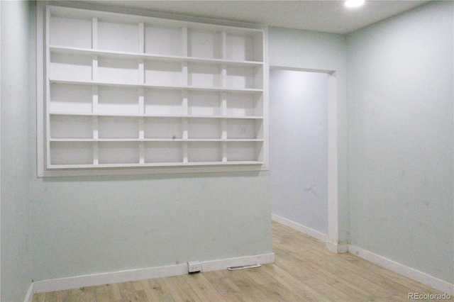 unfurnished room with recessed lighting, baseboards, visible vents, and light wood-style floors