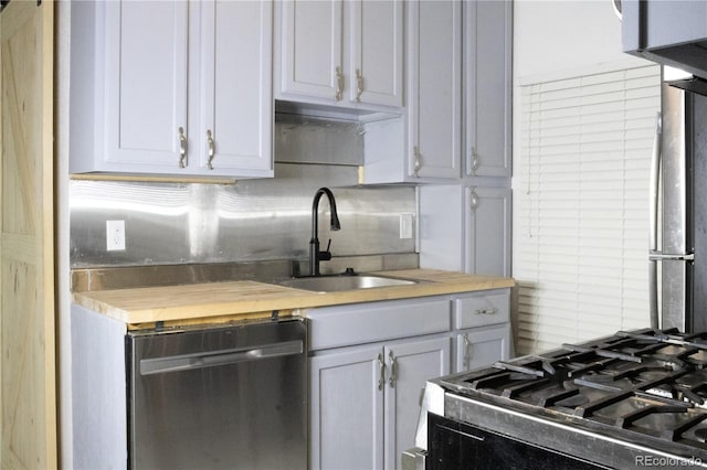 kitchen with a sink, stainless steel dishwasher, and stove