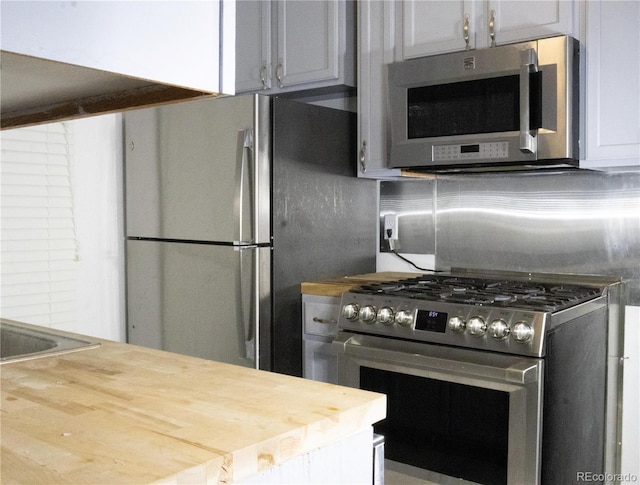 kitchen featuring appliances with stainless steel finishes and butcher block counters