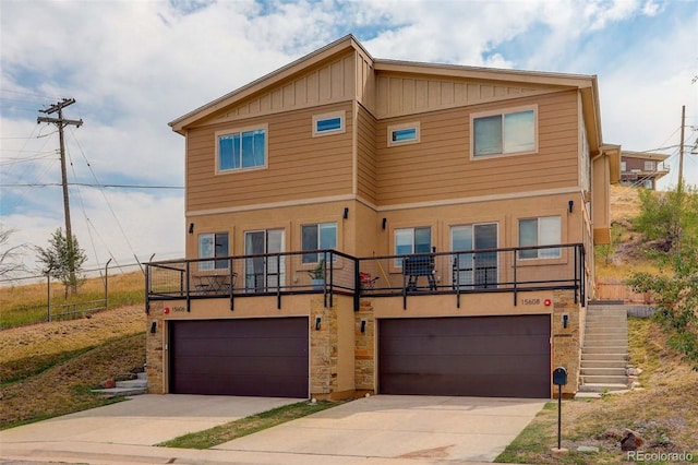 view of front of home with a balcony and a garage