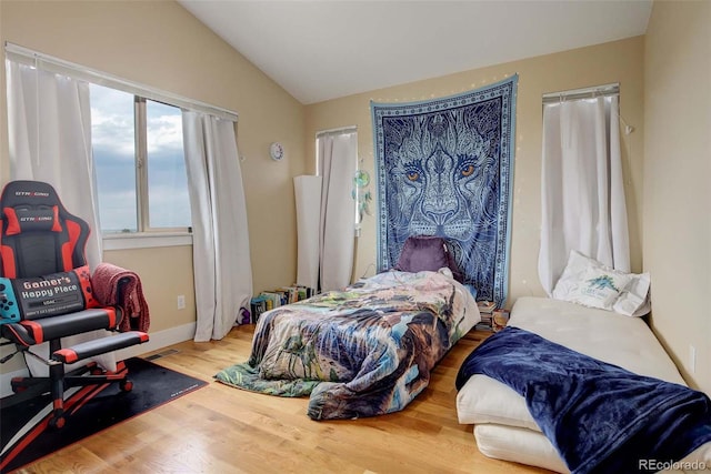 bedroom featuring lofted ceiling and hardwood / wood-style flooring