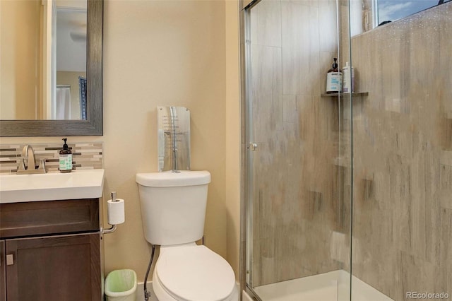 bathroom with vanity, toilet, and a shower with shower door