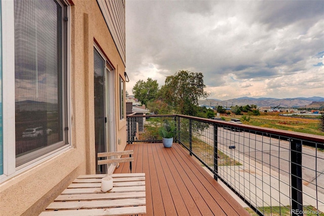 wooden deck with a mountain view