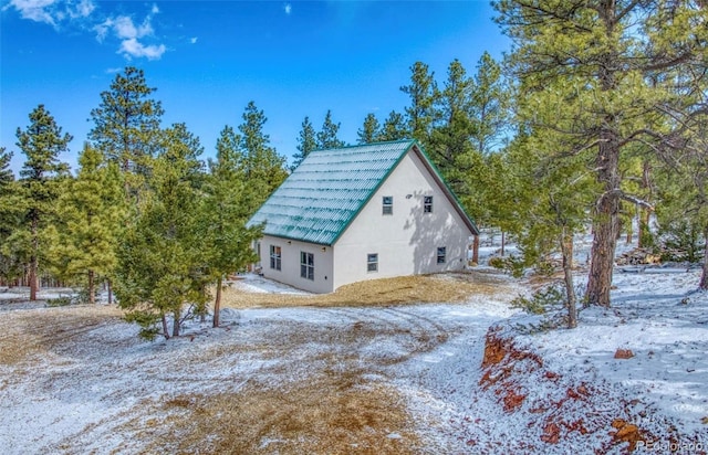 1443 Sangre Dr, Westcliffe, CO 81252 - view of snow covered exterior featuring stucco siding