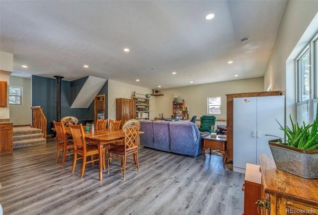 1443 Sangre Dr, Westcliffe, CO 81252 - dining space featuring light wood-style floors, healthy amount of natural light, recessed lighting, and a wood stove