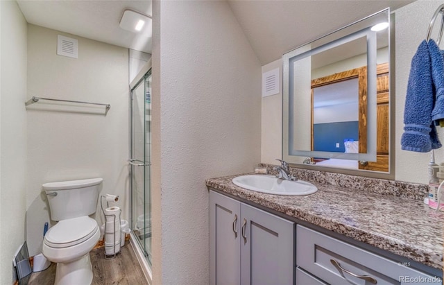 1443 Sangre Dr, Westcliffe, CO 81252 - bathroom featuring toilet, wood finished floors, vanity, a stall shower, and a textured wall