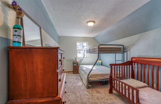 1443 Sangre Dr, Westcliffe, CO 81252 - bedroom with carpet flooring, a textured ceiling, a textured wall, and vaulted ceiling