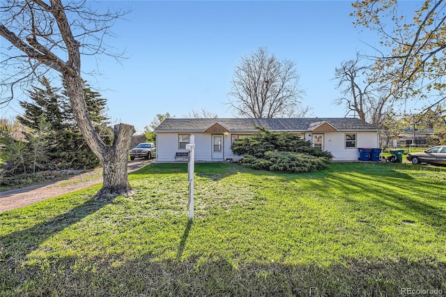 ranch-style house featuring a front lawn