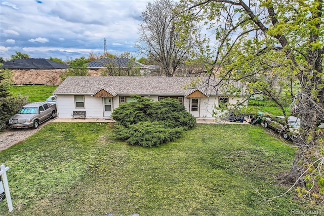 ranch-style home featuring a front yard and a patio