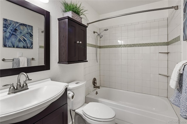 9338 W Utah Pl, Lakewood, CO 80232 - bathroom featuring toilet, vanity, a textured wall, and bathtub / shower combination