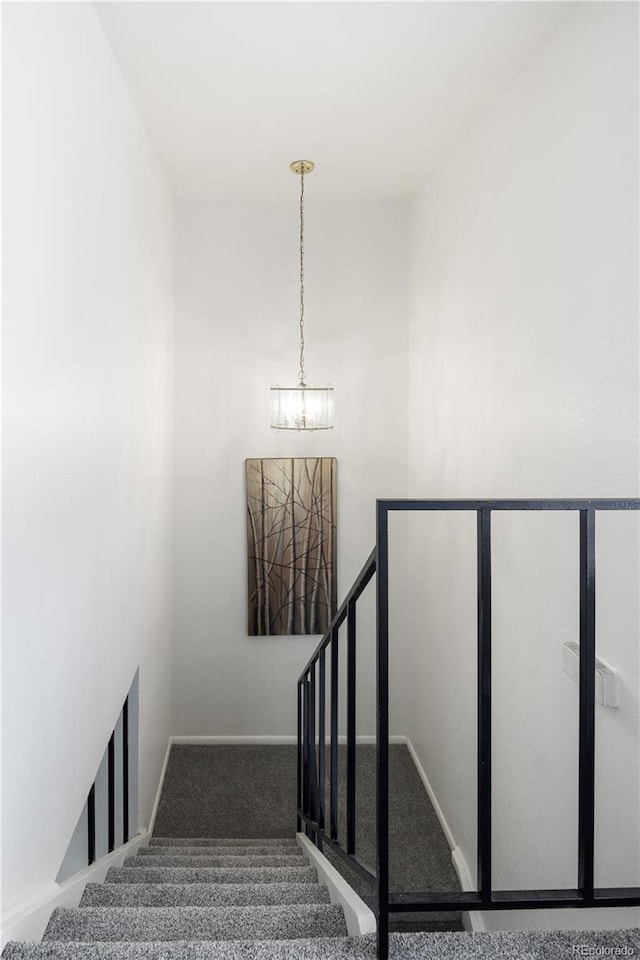 9338 W Utah Pl, Lakewood, CO 80232 - staircase featuring a chandelier, carpet, and baseboards