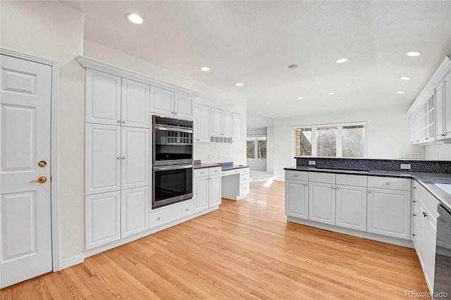 kitchen featuring white cabinetry, stainless steel appliances, and light hardwood / wood-style flooring