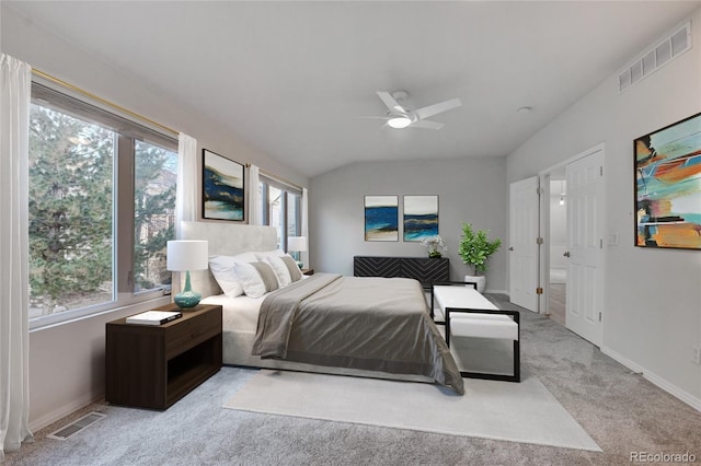 bedroom featuring ceiling fan, vaulted ceiling, and light carpet