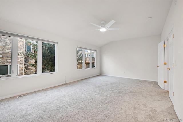 unfurnished room featuring ceiling fan, carpet flooring, and vaulted ceiling