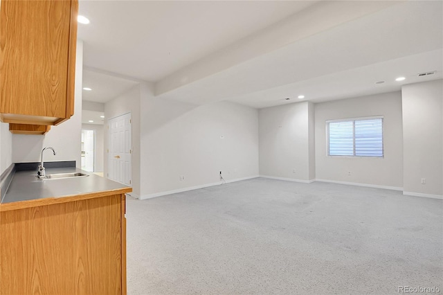 interior space with baseboards, a sink, visible vents, and recessed lighting