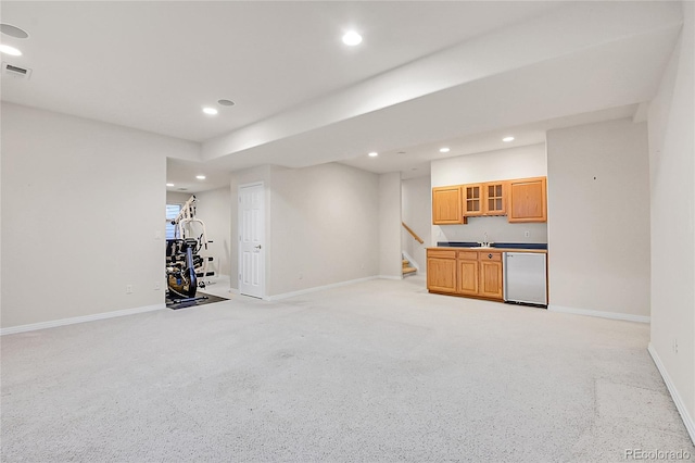 interior space with baseboards, a sink, visible vents, and recessed lighting