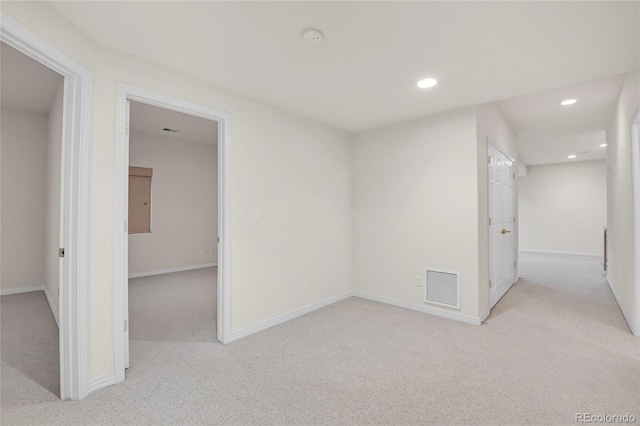 unfurnished room with recessed lighting, visible vents, light carpet, and baseboards