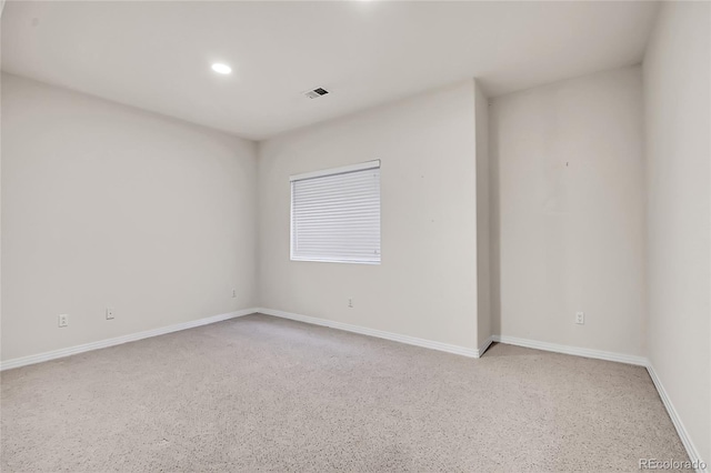 unfurnished room featuring recessed lighting, visible vents, and baseboards