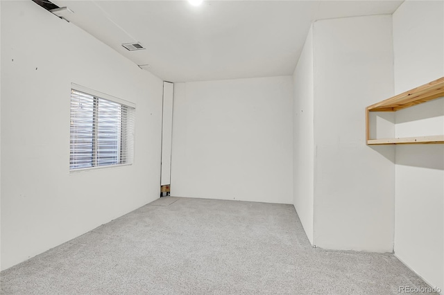 unfurnished room featuring carpet and visible vents