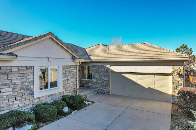 ranch-style home featuring a garage, stone siding, concrete driveway, and stucco siding