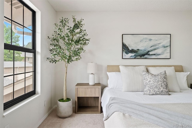 carpeted bedroom featuring baseboards