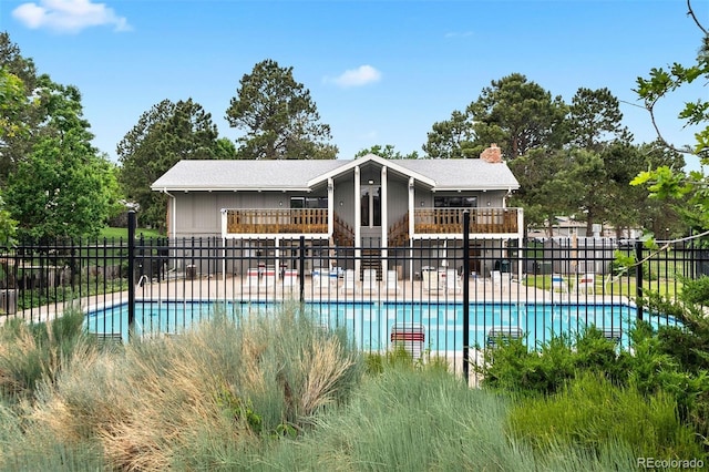 pool with a patio and fence
