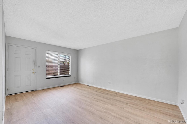 10143 Quivas St, Thornton, CO 80260 - spare room featuring light wood finished floors and a textured ceiling