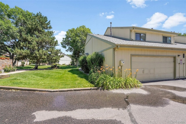10143 Quivas St, Thornton, CO 80260 - view of front of property featuring a front yard, a garage, and asphalt driveway