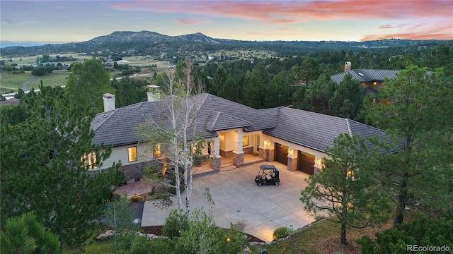 aerial view at dusk featuring a mountain view