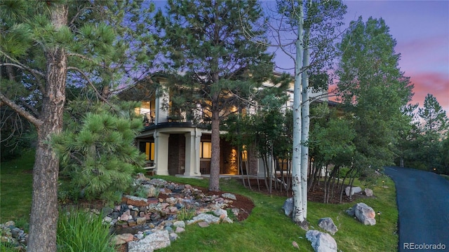 exterior space with a lawn and a balcony