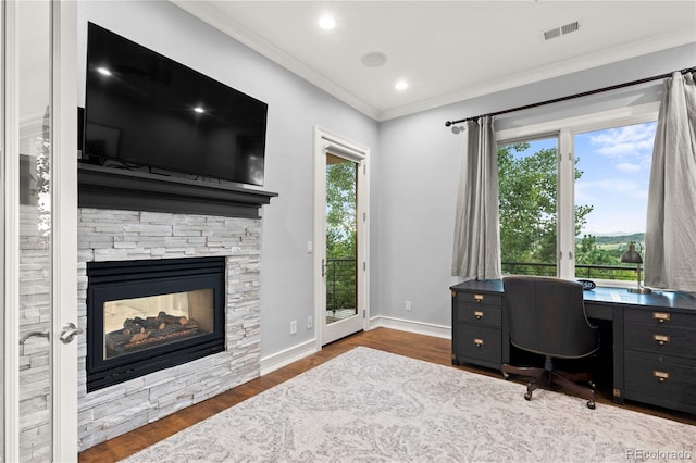 home office with crown molding, a fireplace, and dark wood-type flooring