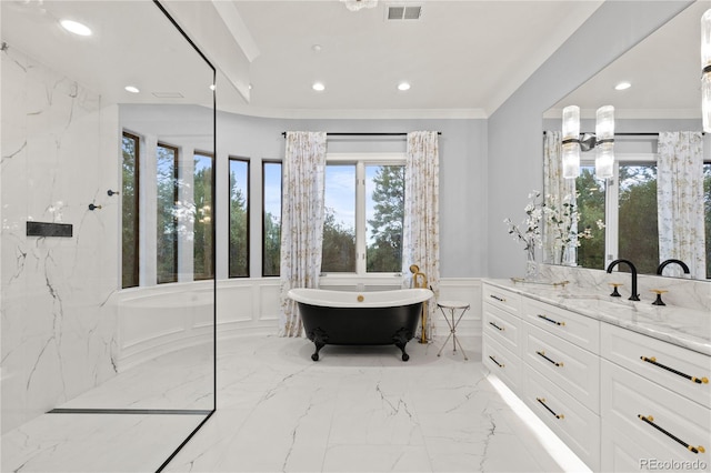 bathroom with a washtub, tile patterned floors, and vanity