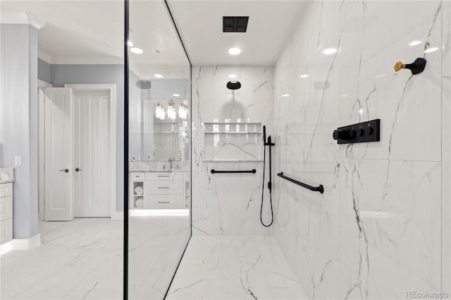 bathroom featuring tile patterned floors, vanity, and tiled shower