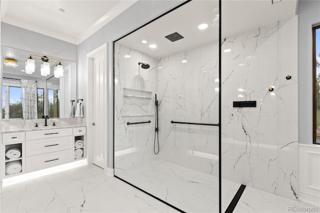 bathroom featuring tiled shower, crown molding, tile patterned flooring, and vanity