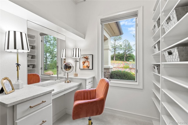 carpeted office featuring built in desk