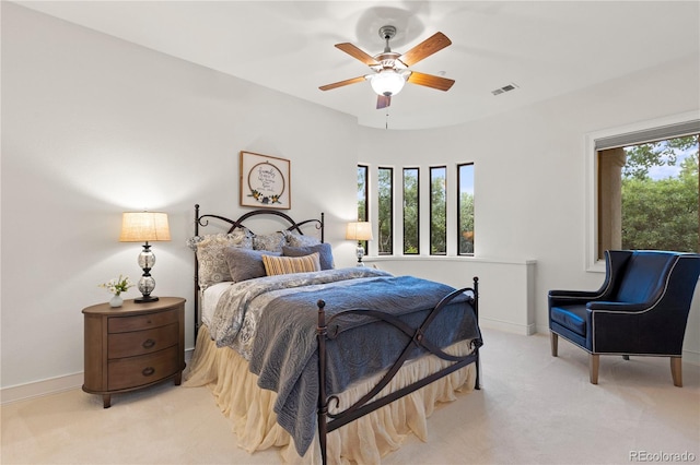 carpeted bedroom with multiple windows and ceiling fan