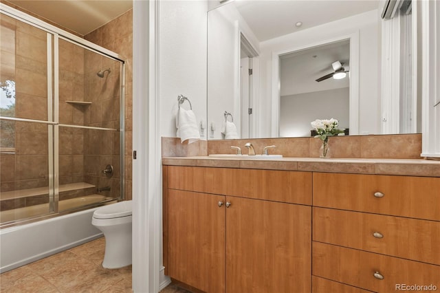 full bathroom featuring enclosed tub / shower combo, vanity, tile patterned flooring, ceiling fan, and toilet